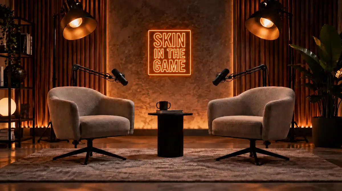 Skin In The Game podcast studio with two chairs and orange neon sign